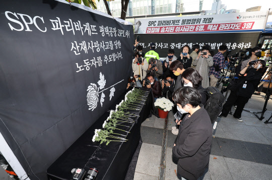20일 오후 서울 양재동 SPC 본사 앞에서 열린 평택 SPC 계열사 SPL의 제빵공장 사망 사고 희생자 서울 추모행사에서 참가자들이 헌화하고 있다. 연합뉴스